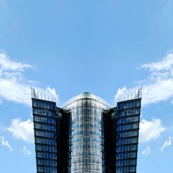 Low angle view of modern building against blue sky