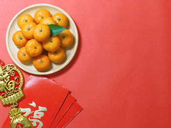 Close-up of orange fruits in plate on table