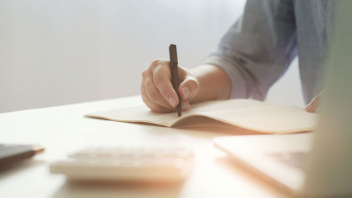 Close-up of hand holding book
