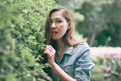 Portrait of young woman looking at camera