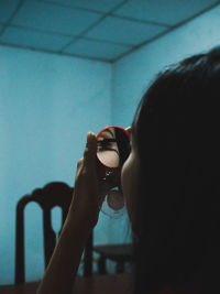 Close-up of woman holding mirror