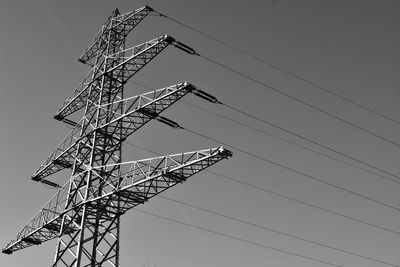 Low angle view of electricity pylon against sky