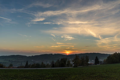 Scenic view of field against sky during sunset