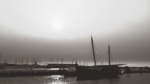 Sailboats sailing in sea against sky