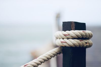 Close-up of rope tied on railing