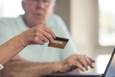 Senior couple shopping online with credit card