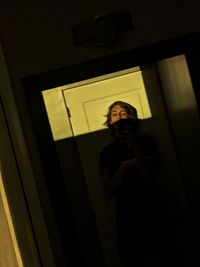 Low angle view of woman standing at home