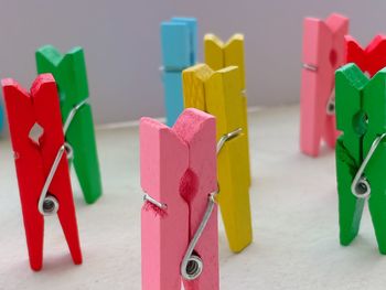 Close-up of multi colored clothespins on table