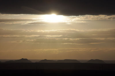 Scenic view of silhouette mountains against sky during sunset