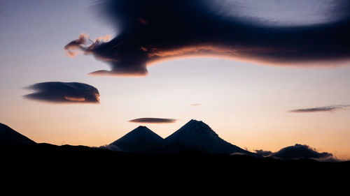 Scenic view of silhouette mountains against sky during sunset