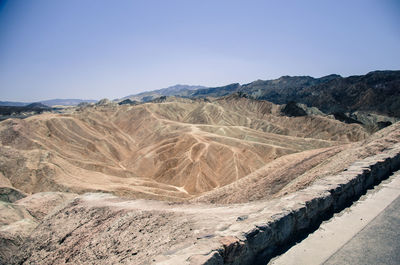 Scenic view of mountains against clear blue sky