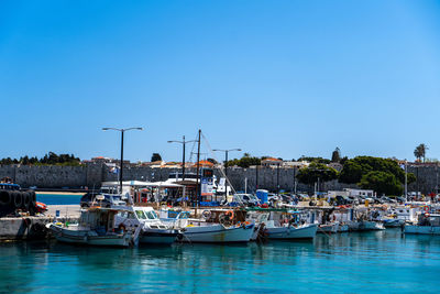 Boats moored at harbor