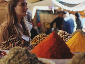 Young woman standing at market stall