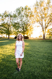 Portrait of smiling woman standing on field