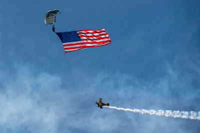 Low angle view of airplane flying against sky