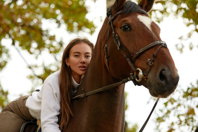 Portrait of young woman riding horse