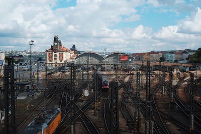 Railroad tracks by buildings against sky