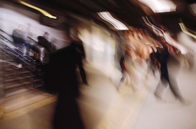 Blurred motion of people walking in train