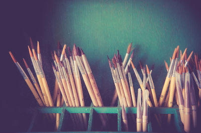 Close-up of multi colored pencils against gray background