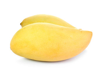 Close-up of yellow fruit against white background