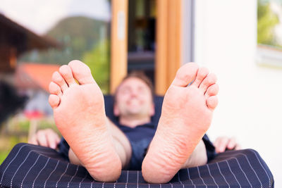 Low section of man sleeping woman