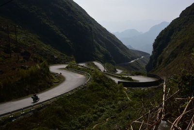 High angle view of road amidst mountains against sky