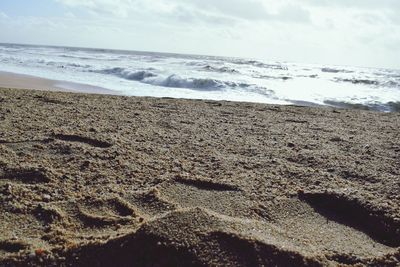 Scenic view of beach against sky