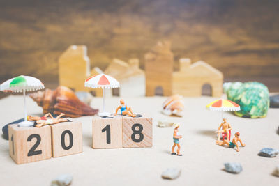 Figurines and toy blocks with numbers over table