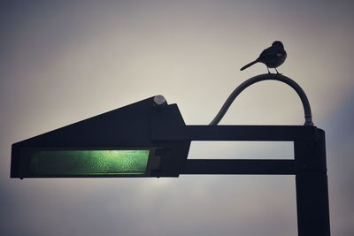 Low angle view of street light against sky