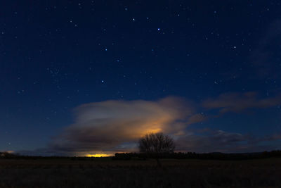 Scenic view of field against sky at night