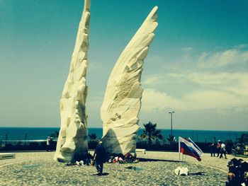 People on beach against sky