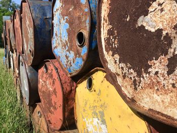 Close-up of rusty old abandoned car on field