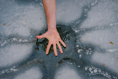 Low section of person standing on snow