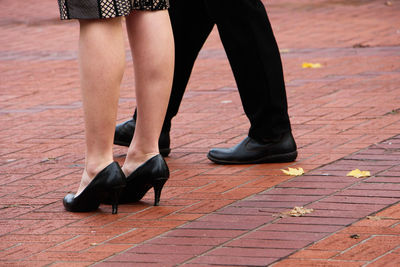 Low section of people standing on street