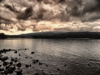 Scenic view of lake against cloudy sky