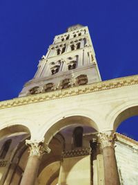 Low angle view of historical building against clear blue sky