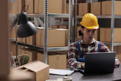 Rear view of man working in factory