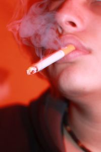 Close-up of young woman smoking cigarette