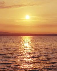 Scenic view of sea against orange sky