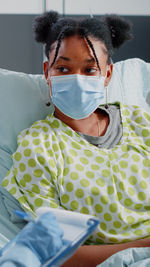Patient wearing mask resting at bed at home