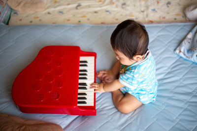High angle view of cute baby on bed at home