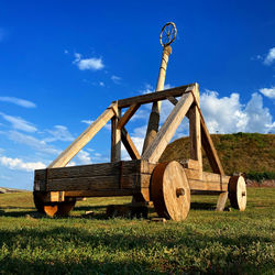 Traditional windmill on field against sky