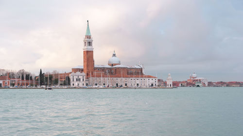 View of castle by sea against sky