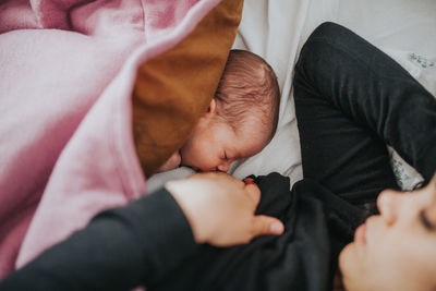 Close-up of baby sleeping on bed