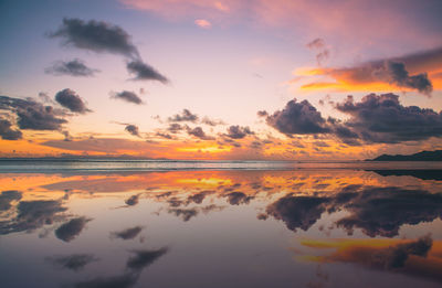 Scenic view of sea against romantic sky at sunset