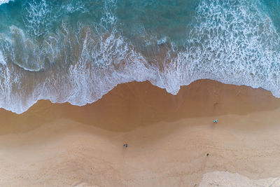 Aerial view of people enjoying on beach