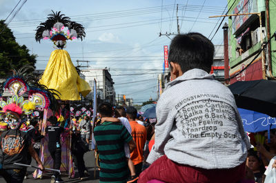 Rear view of people against sky