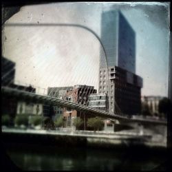 Reflection of buildings in city seen through glass