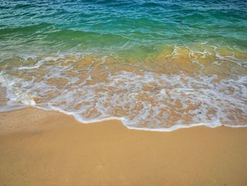 High angle view of waves rushing towards shore