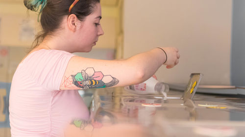 Portrait of woman with mobile phone on table